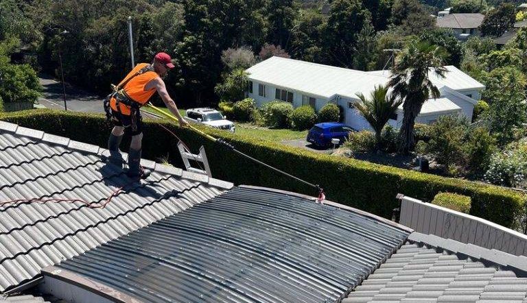 A man cleaning a roof flashing.